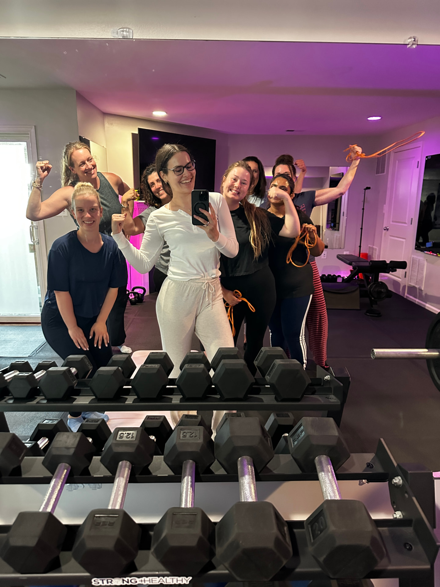 Strong & Healthy members celebrating together at the end of a group training session